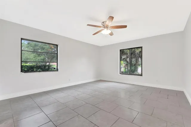 a bathroom with a granite countertop sink mirror vanity and toilet