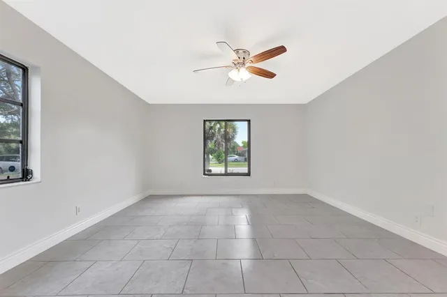 a bathroom with a granite countertop sink mirror vanity and toilet