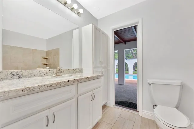 a view of a backyard with pool table and chairs