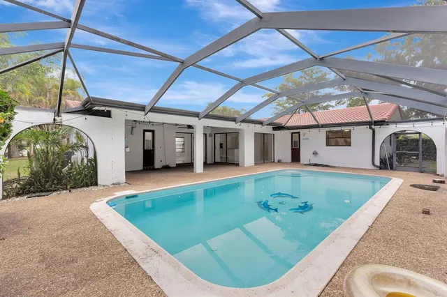 a view of a house with backyard and sitting area