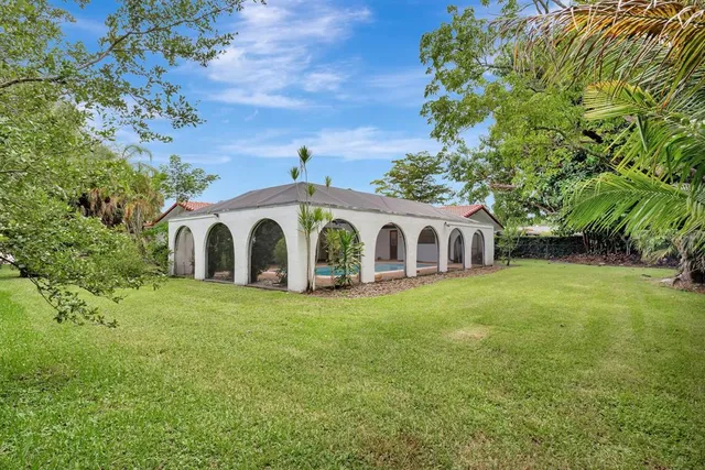 an aerial view of a house with a yard and lake view