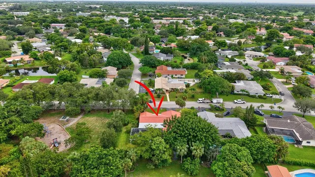 an aerial view of a house with a yard