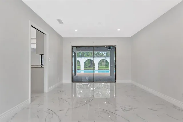 an empty room with windows and yard