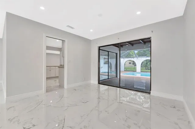 an empty room with windows and closet