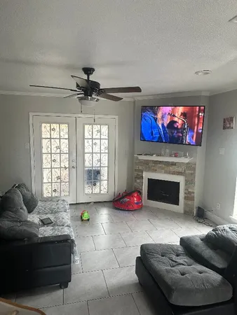 a living room with furniture a fireplace and a flat screen tv