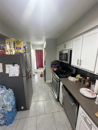 a kitchen with a sink stove and refrigerator
