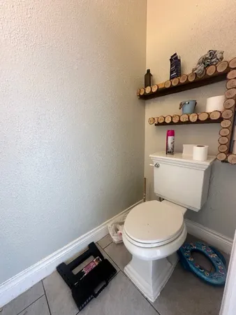 a white toilet sitting next to a bathroom sink and vanity