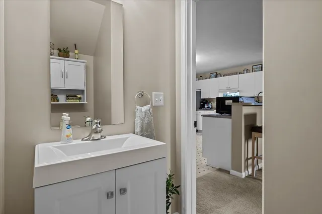 a kitchen with a sink refrigerator and cabinets