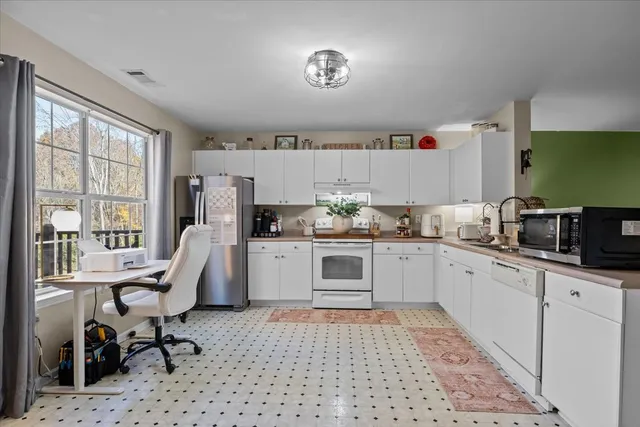 a kitchen with a sink cabinets and window