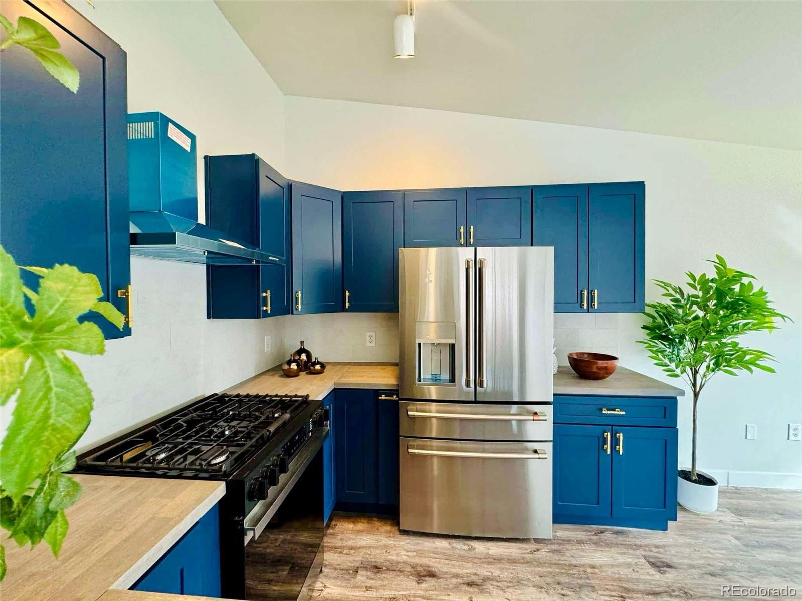 8468 South Thunder Ridge Way, Unit 202 Highlands Ranch, CO 80126 - Photo 3 of 21 a kitchen with stainless steel appliances granite countertop a refrigerator stove and wooden cabinets