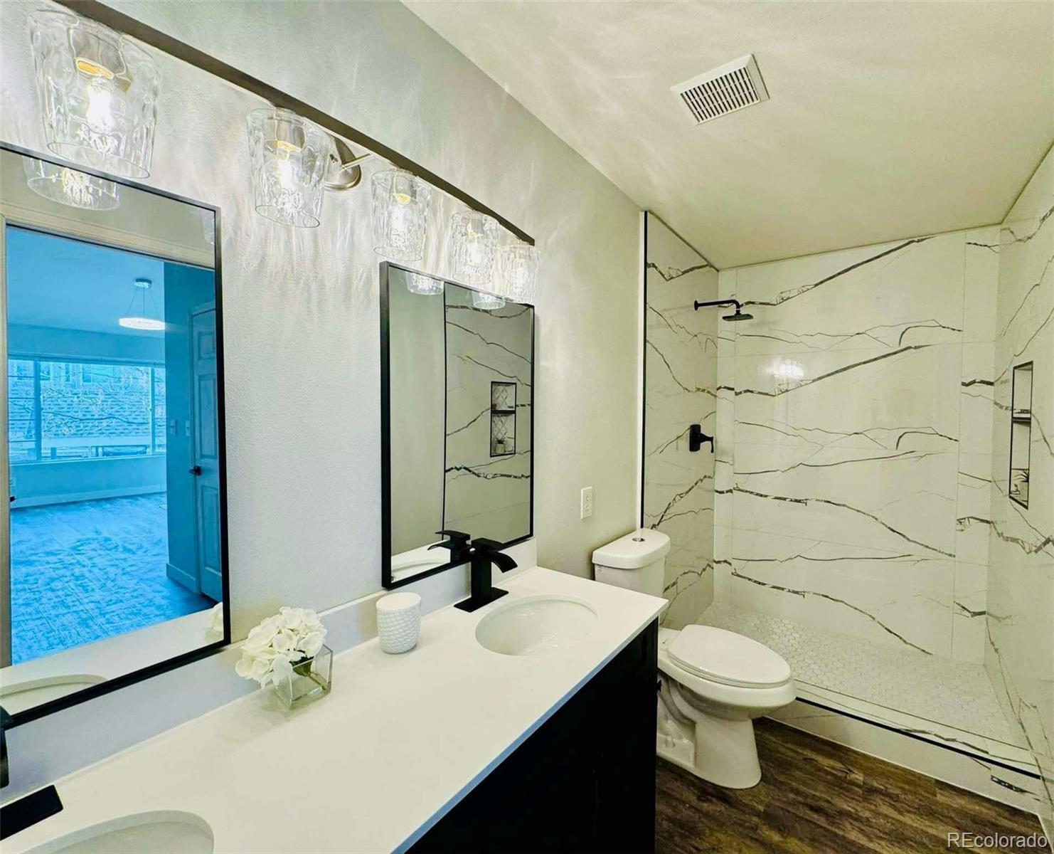 8468 South Thunder Ridge Way, Unit 202 Highlands Ranch, CO 80126 - Photo 4 of 21 a bathroom with a sink toilet and shower