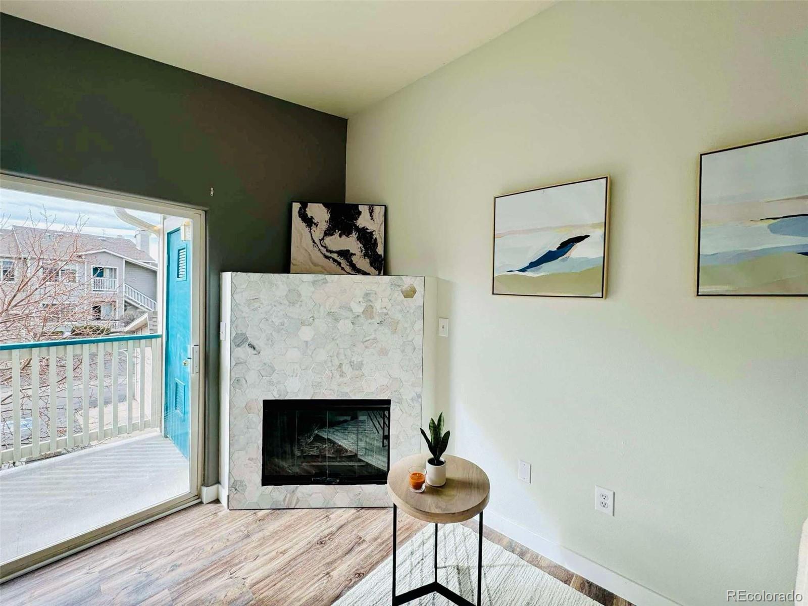 8468 South Thunder Ridge Way, Unit 202 Highlands Ranch, CO 80126 - Photo 6 of 21 a living room with furniture and a fireplace