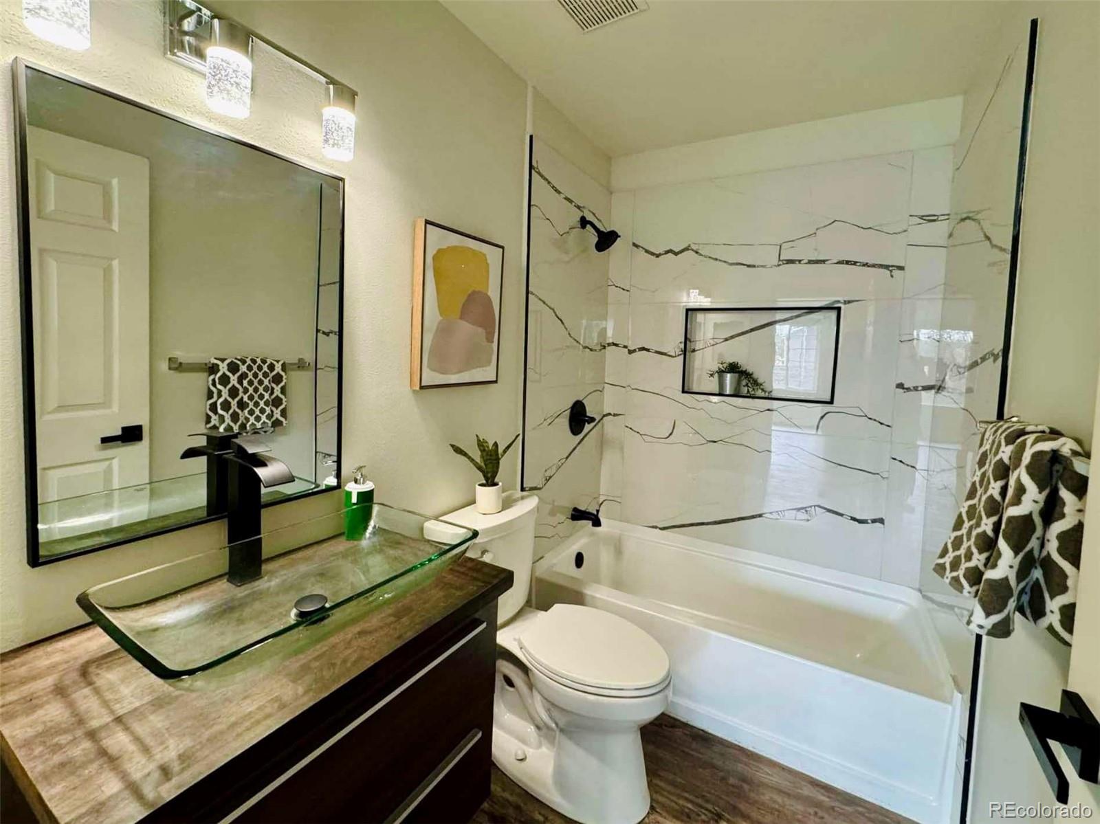 8468 South Thunder Ridge Way, Unit 202 Highlands Ranch, CO 80126 - Photo 10 of 21 a bathroom with a sink a toilet and shower