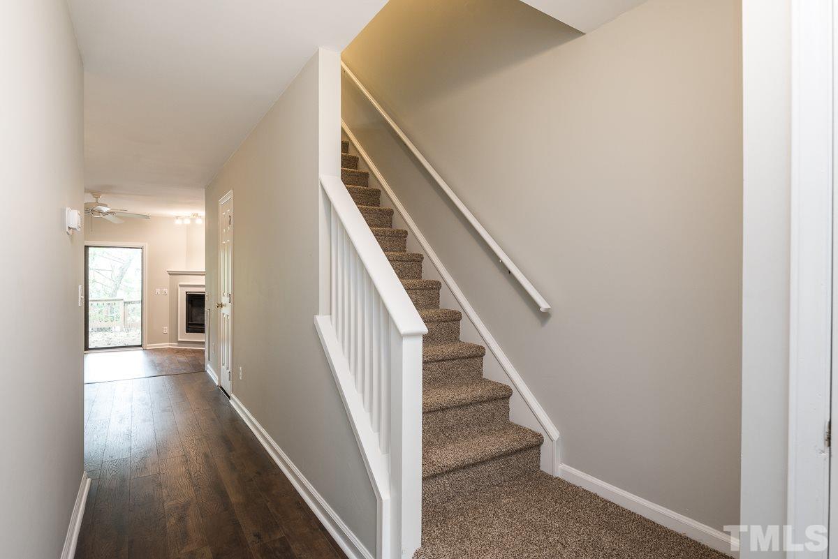 4213 Sunshadow Lane Raleigh, NC 27613 - Photo 2 of 20 a view of a hallway with wooden floor