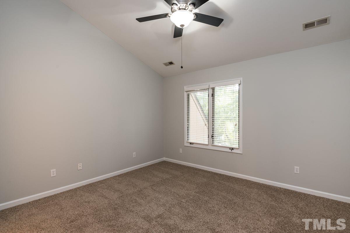 4213 Sunshadow Lane Raleigh, NC 27613 - Photo 17 of 20 an empty room with a window and a fan