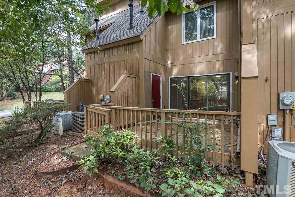 4213 Sunshadow Lane Raleigh, NC 27613 - Photo 18 of 20 a view of a house with brick walls and a small yard