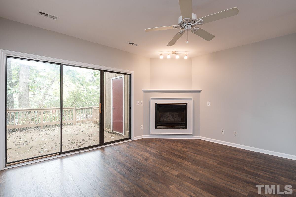 4213 Sunshadow Lane Raleigh, NC 27613 - Photo 3 of 20 a view of an empty room with a fireplace and a window