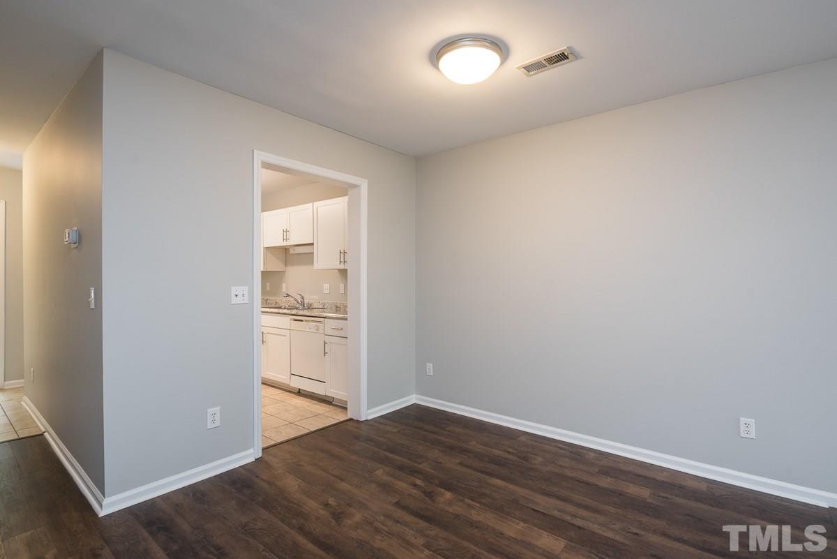 4213 Sunshadow Lane Raleigh, NC 27613 - Photo 7 of 20 an empty room with wooden floor and windows