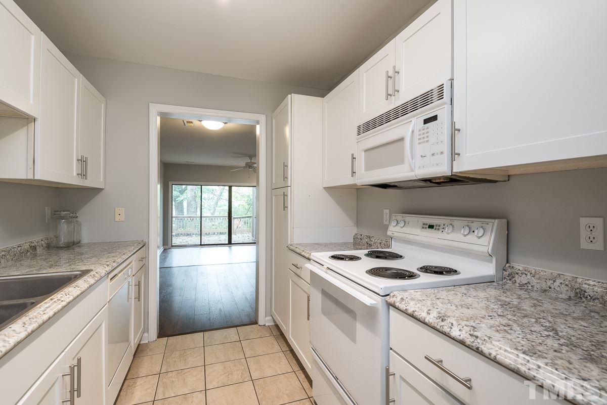 4213 Sunshadow Lane Raleigh, NC 27613 - Photo 9 of 20 a kitchen with stainless steel appliances granite countertop a stove a sink and a microwave