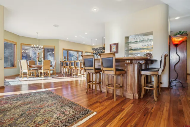 a kitchen with stainless steel appliances granite countertop a sink a stove and a wooden floors