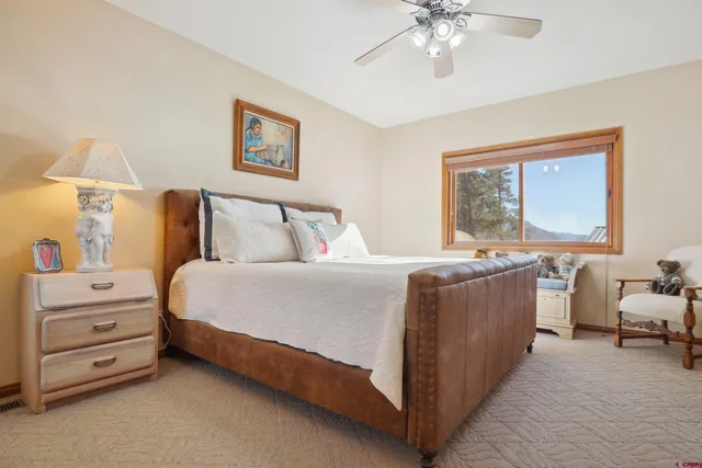 a bedroom with a bed dresser and a window