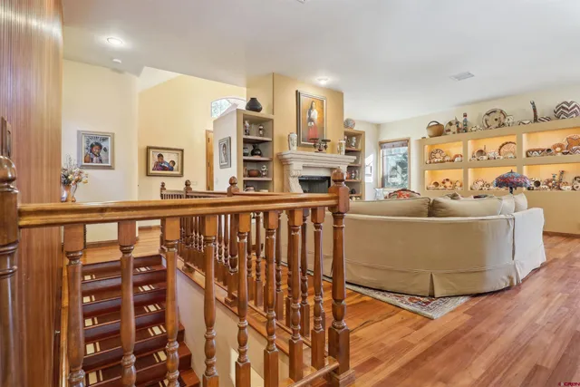 a view of a dining room with furniture a chandelier and wooden floor