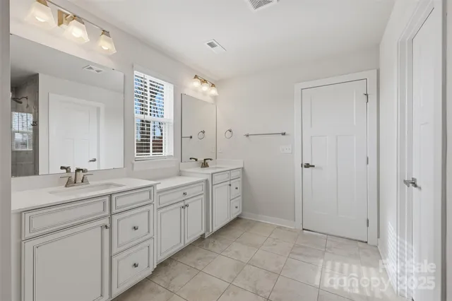 a bathroom with a granite countertop sink mirror and double