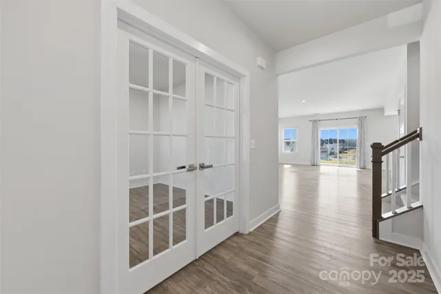 a view of a livingroom with wooden floor and a large window