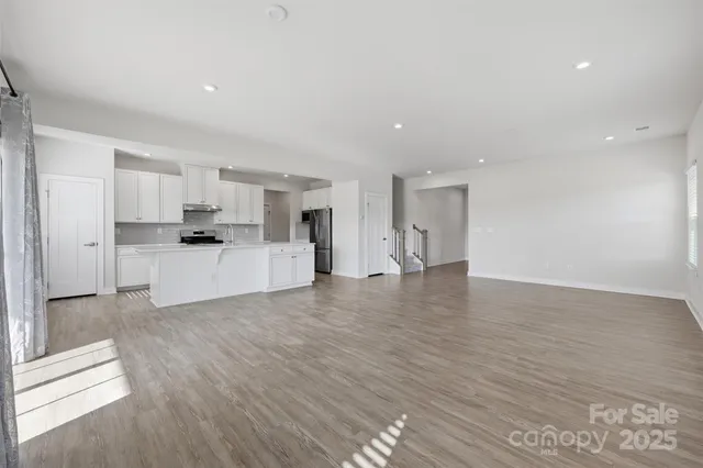a view of a kitchen with a sink and a refrigerator