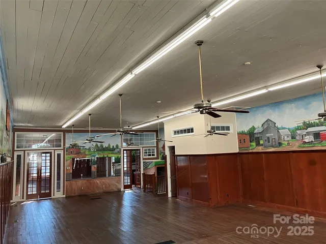 a view of a room with wooden floor