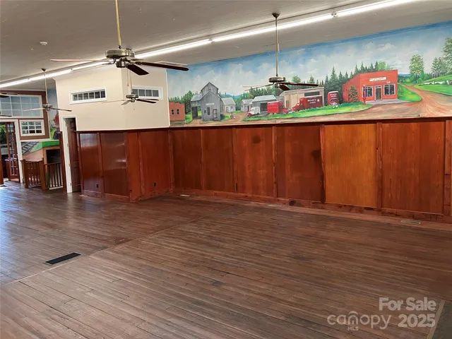 a kitchen with stainless steel appliances granite countertop a sink window and cabinets