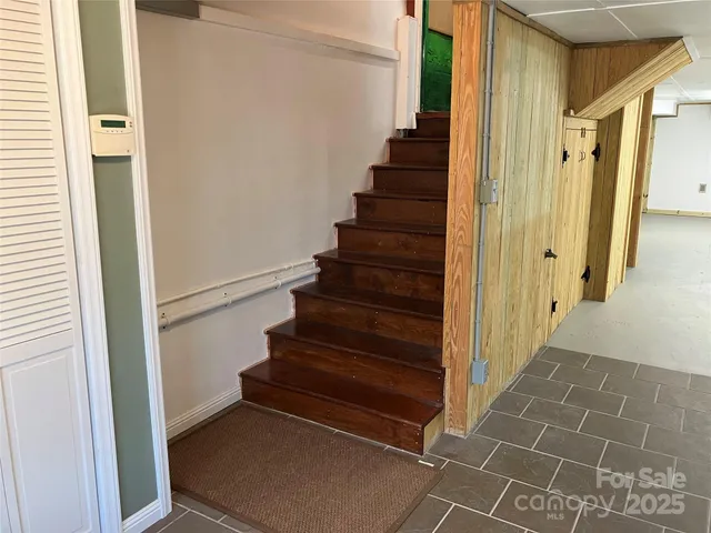 a view of entryway with stairs and a white door