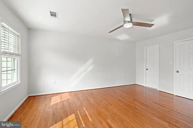 wooden floor in an empty room with a window