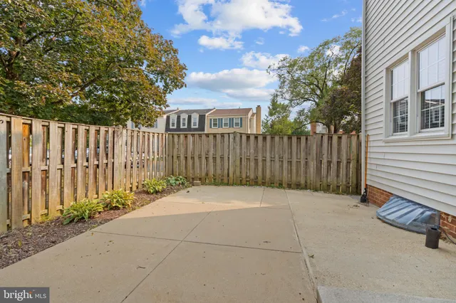 a view of backyard with wooden fence