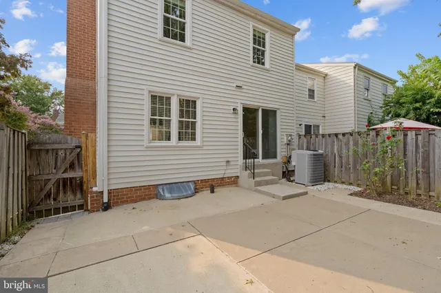 a backyard of a house with barbeque oven and glass door