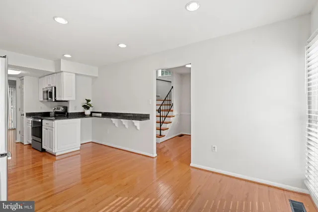 a view of kitchen with wooden floor and electronic appliances