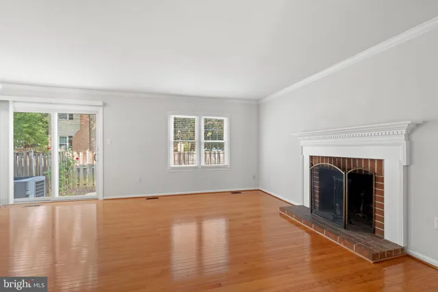 a view of an empty room with glass door and a window
