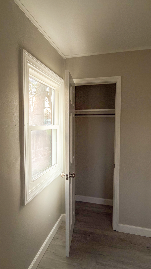 1037 Eastview Drive Rantoul, IL 61866 - Photo 12 of 21 a view of an empty room with wooden floor and a window