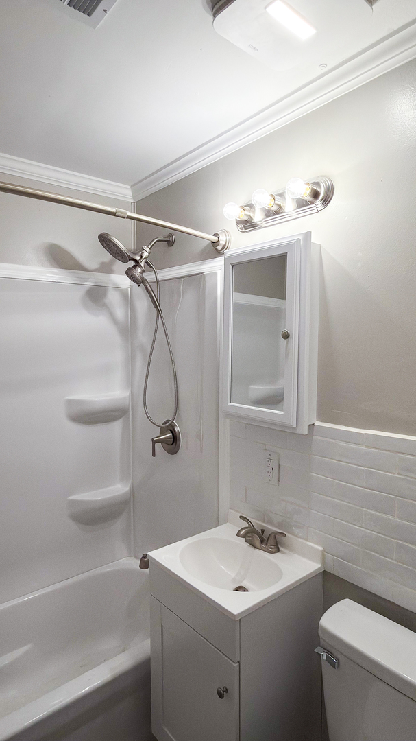 1037 Eastview Drive Rantoul, IL 61866 - Photo 13 of 21 a bathroom with a sink a toilet and shower