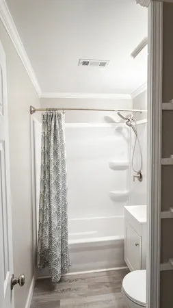 a bathroom with a shower curtain and a toilet