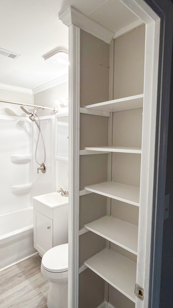 1037 Eastview Drive Rantoul, IL 61866 - Photo 15 of 21 a bathroom with a toilet a sink and a shower