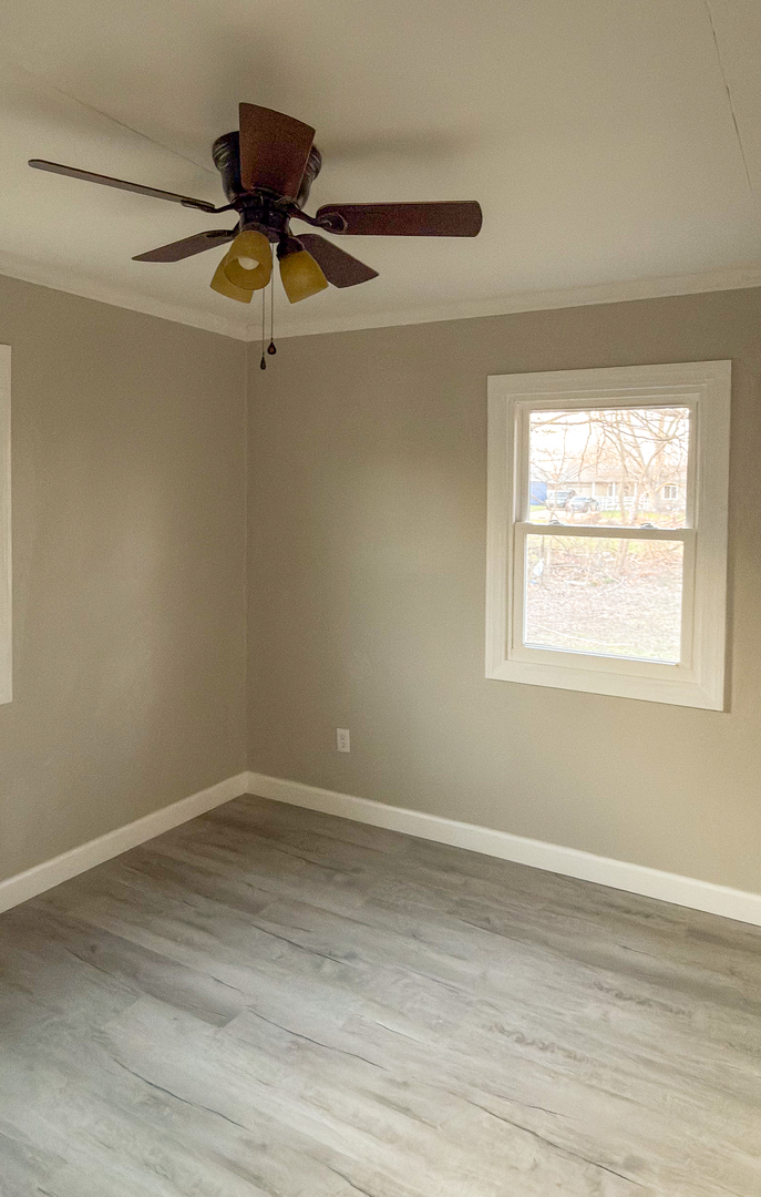 1037 Eastview Drive Rantoul, IL 61866 - Photo 16 of 21 a view of room window and wooden floor