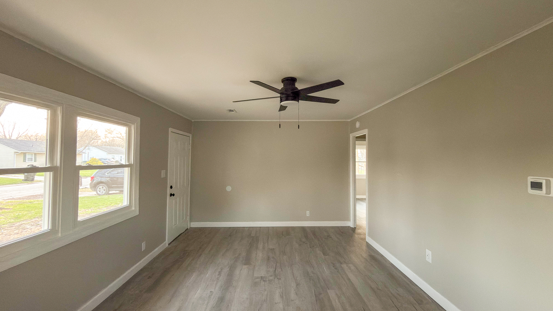 1037 Eastview Drive Rantoul, IL 61866 - Photo 6 of 21 wooden floor in an empty room with a window
