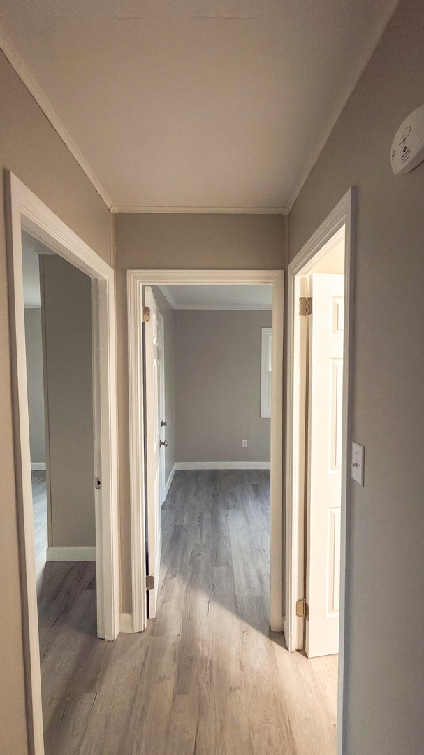 1037 Eastview Drive Rantoul, IL 61866 - Photo 8 of 21 an empty room with wooden floor and windows
