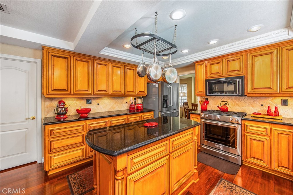 7751 Jack Rabbit Lane Highland, CA 92346 - Photo 13 of 50 a kitchen with stainless steel appliances granite countertop a sink and cabinets