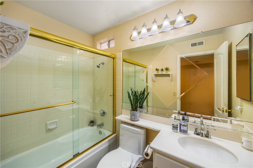7751 Jack Rabbit Lane Highland, CA 92346 - Photo 20 of 50 a bathroom with a bathtub shower sink mirror and toilet