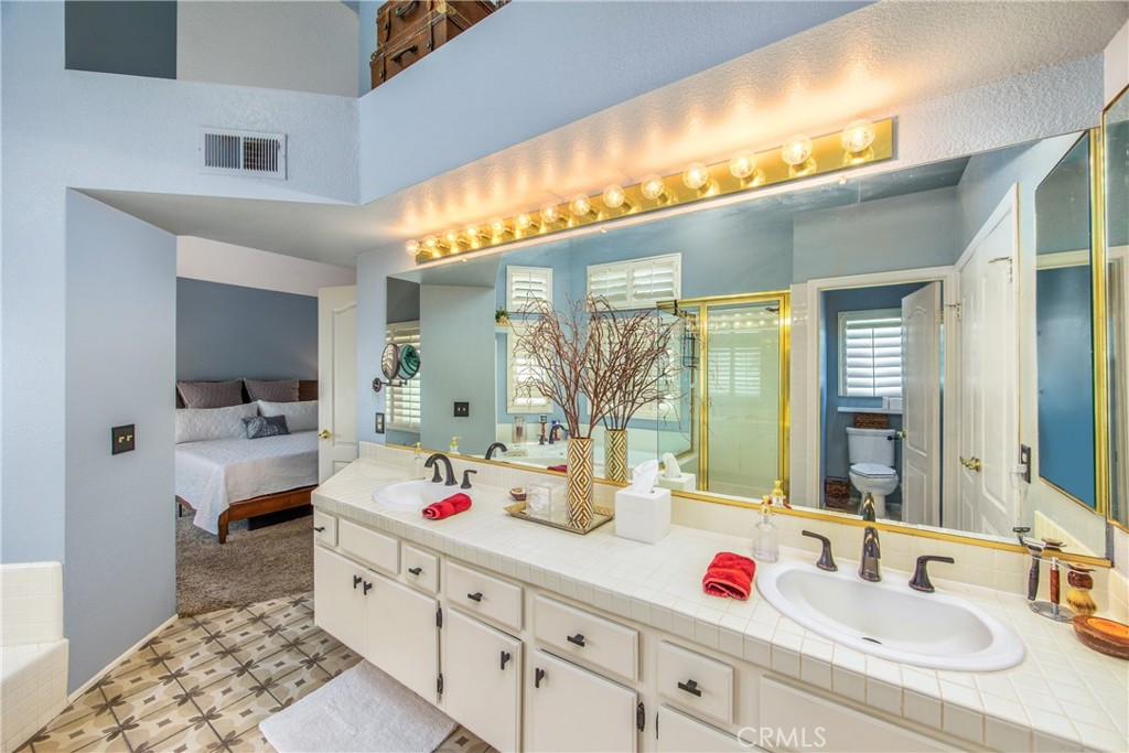 7751 Jack Rabbit Lane Highland, CA 92346 - Photo 28 of 50 a bathroom with a sink double vanity and a mirror