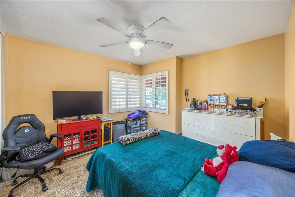 7751 Jack Rabbit Lane Highland, CA 92346 - Photo 32 of 50 a bedroom with a bed and a window