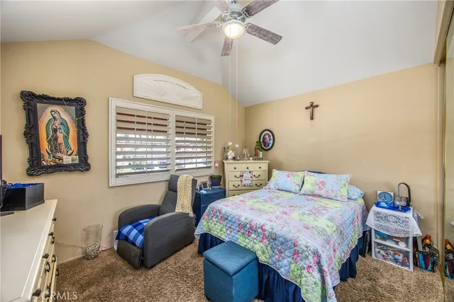 a bedroom with a bed and a couch