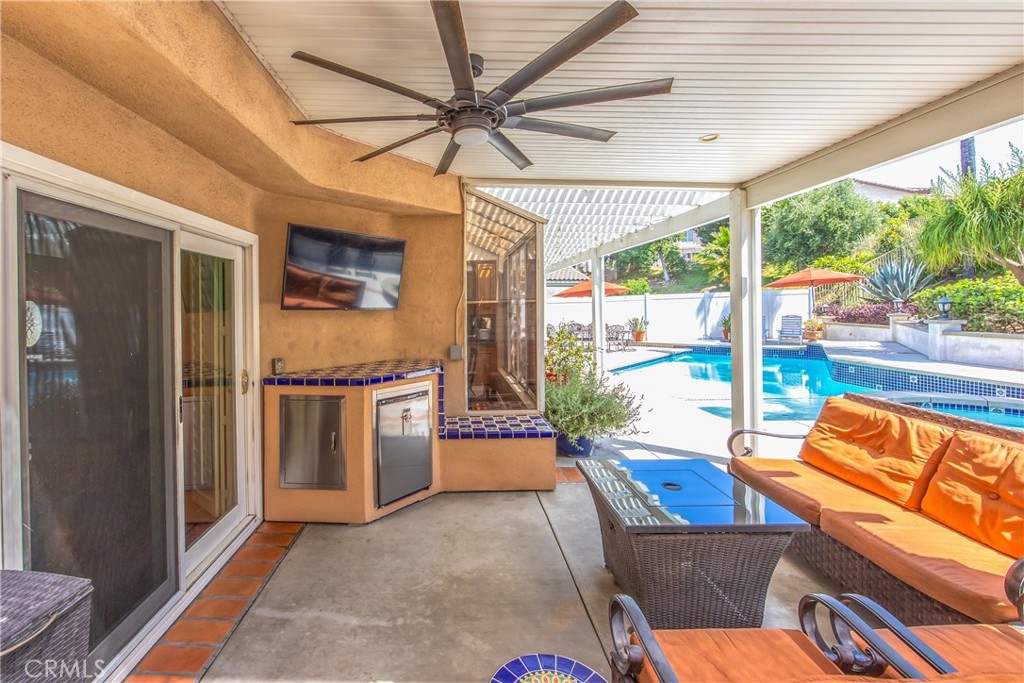 7751 Jack Rabbit Lane Highland, CA 92346 - Photo 37 of 50 a living room with furniture a ceiling fan and a large window